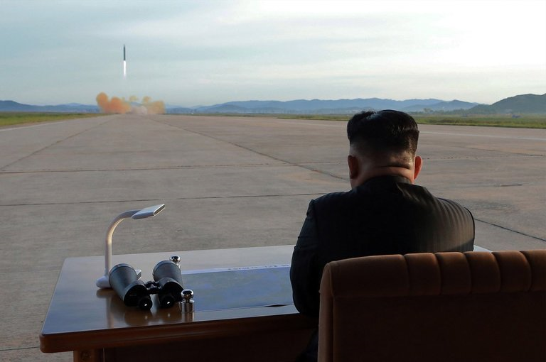 Kim Jong Un watches the launch of a Hwasong-12 IRBM